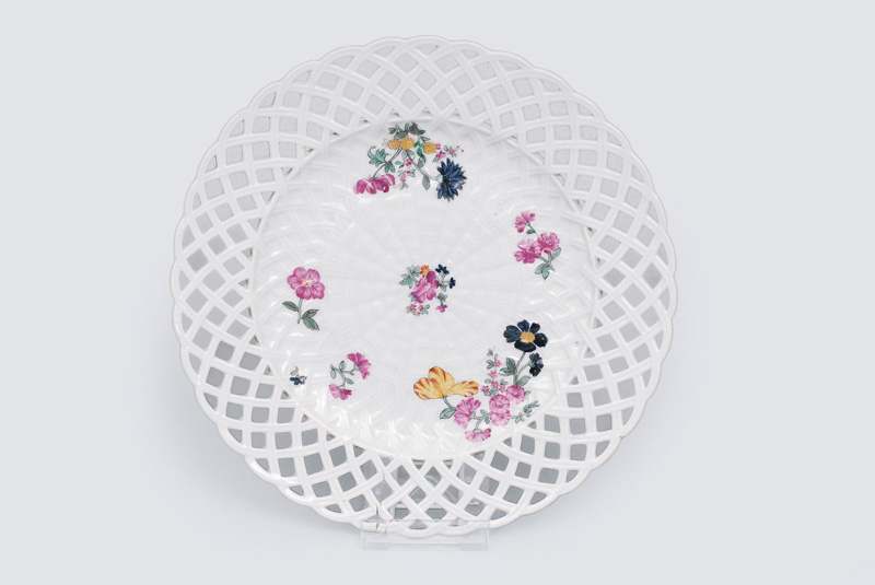 An openwork plate with stylised flowers