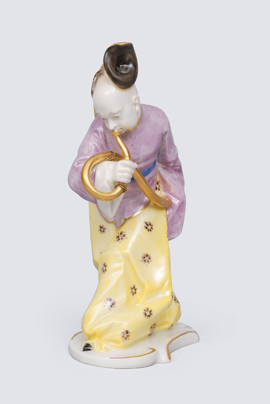 A figurine "Chines playing the serpent"