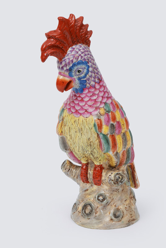 A big animal figurine "parrot" on branch base