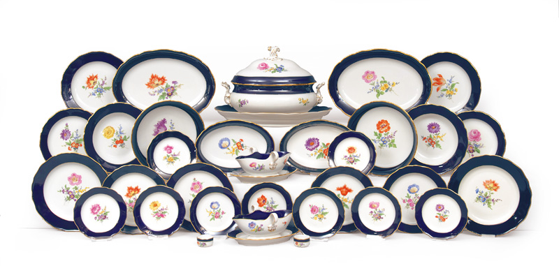 A dinner service with flower painting, cobalt and gilded rim for 12 persons