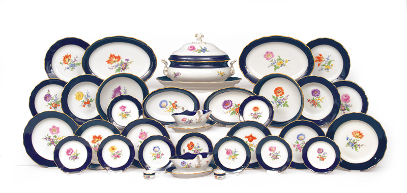 - A dinner service with flower painting, cobalt and gilded rim for 12 persons A dinner service with flower painting, cobalt and gilded rim for 12 persons