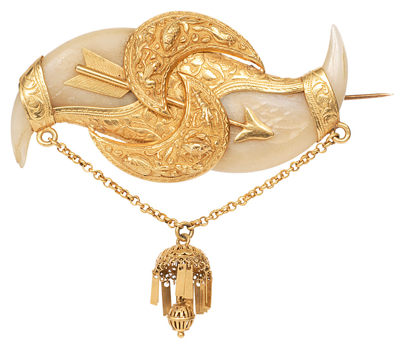 An antique claw brooch with golden mounting