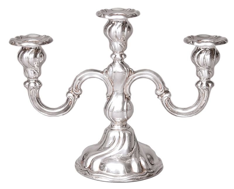 A candleholder in the style of Chippendale