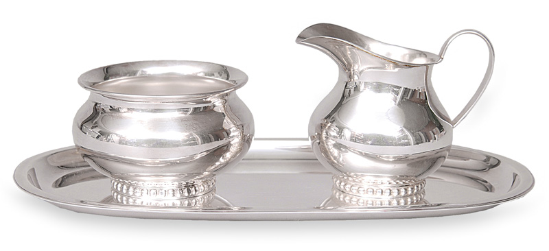 A set of creamer and sugar bowl on tray