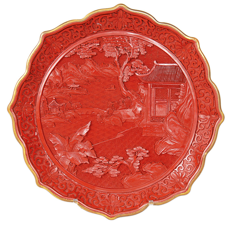 A red laquer plate with landscape