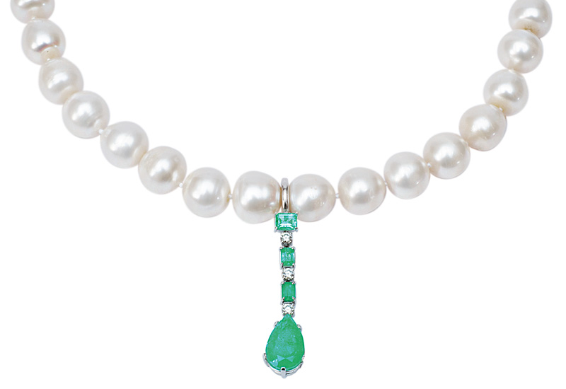 A pearl necklace with emerald diamond pendant