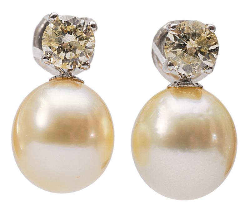 A pair of pearl earrings with diamonds