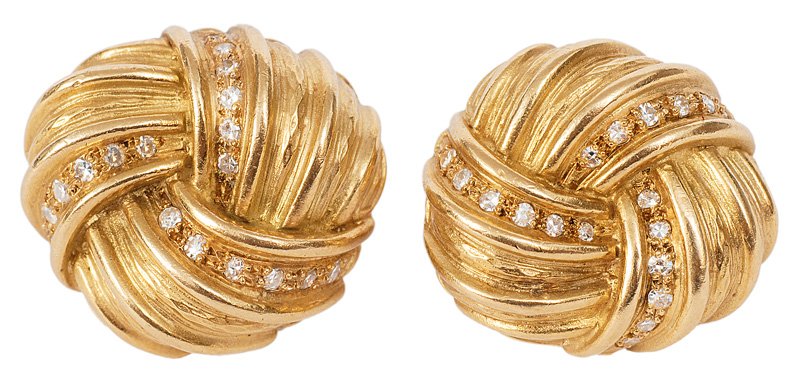 A pair of golden earclips with diamonds
