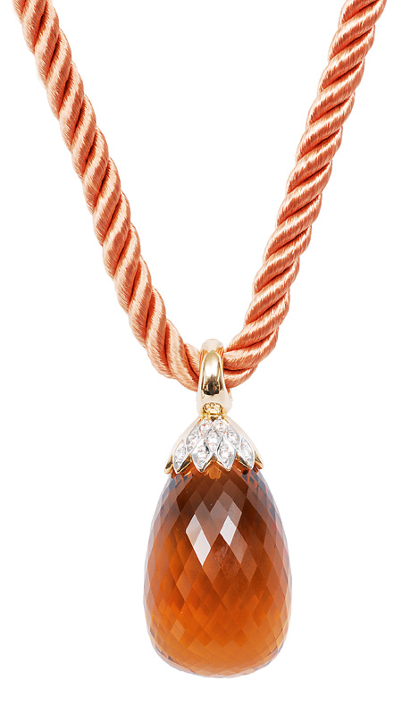 A large citrine pendant with silk necklace