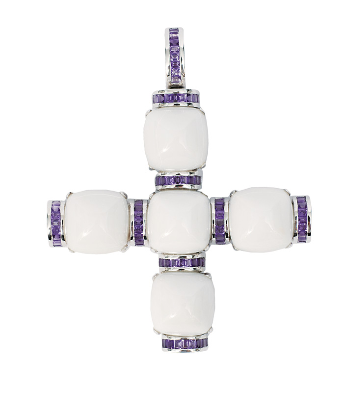 A cross shaped milky quartz pendant with amethysts