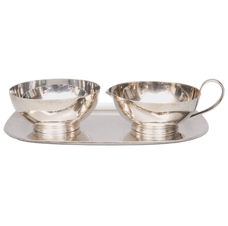 A set of creamer and sugar bowl on tray