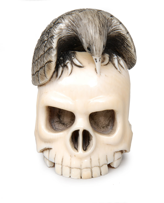 A Netsuke with eagle, head and erotically figure A Netsuke with eagle, head and erotically figure