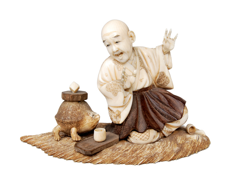 An okimono - Sitting monk drinking tea