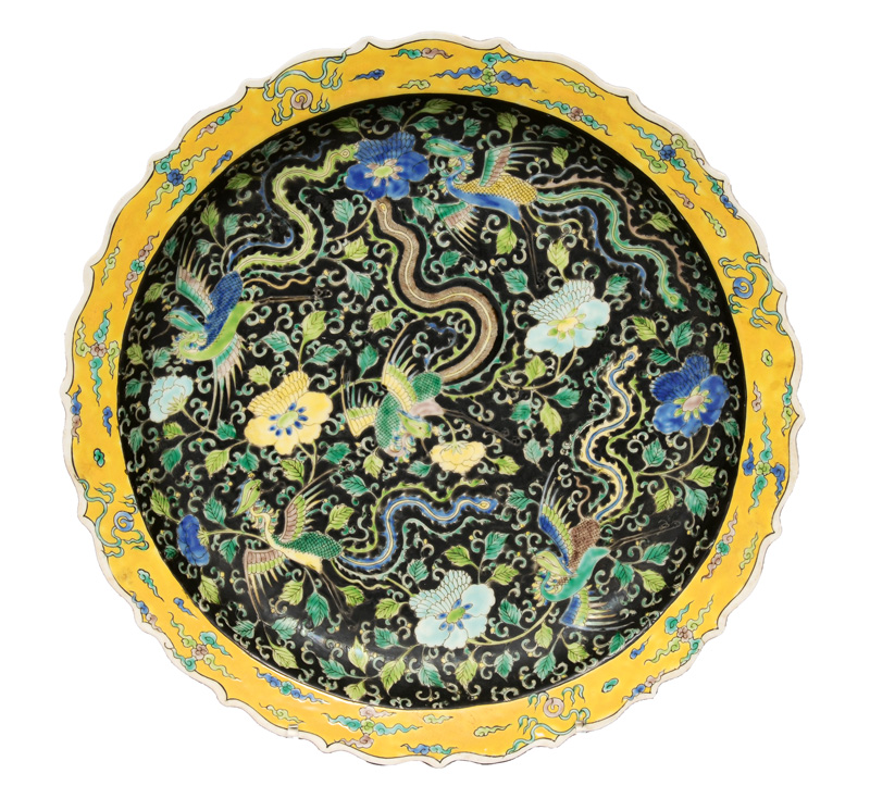 A large Famille Noir plate with phoenix decor