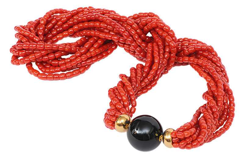 A coral necklace with an onyx gold clasp