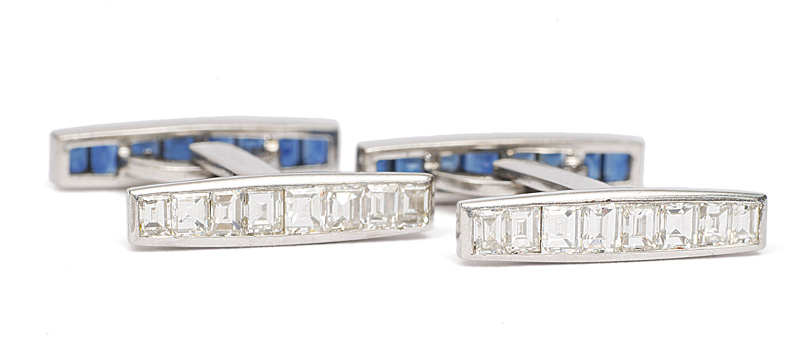 A pair of cuff links with diamonds and sapphires