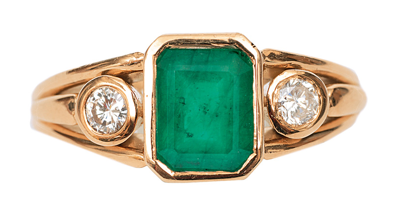 An emerald diamond ring