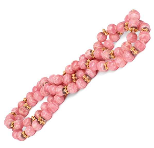 A long, decorative rhodochrosite necklace