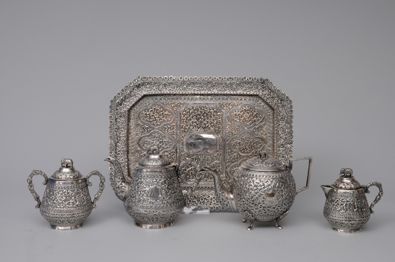 A tea service with elephant handles