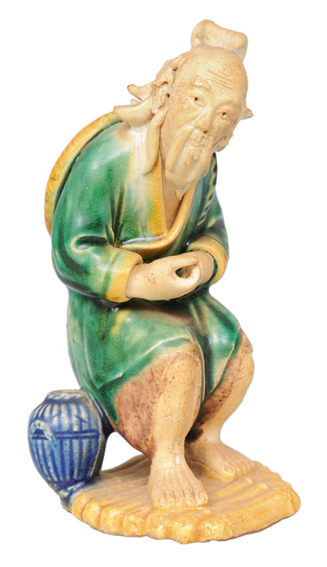 A figurine "Fisherman on a mat of bamboo"
