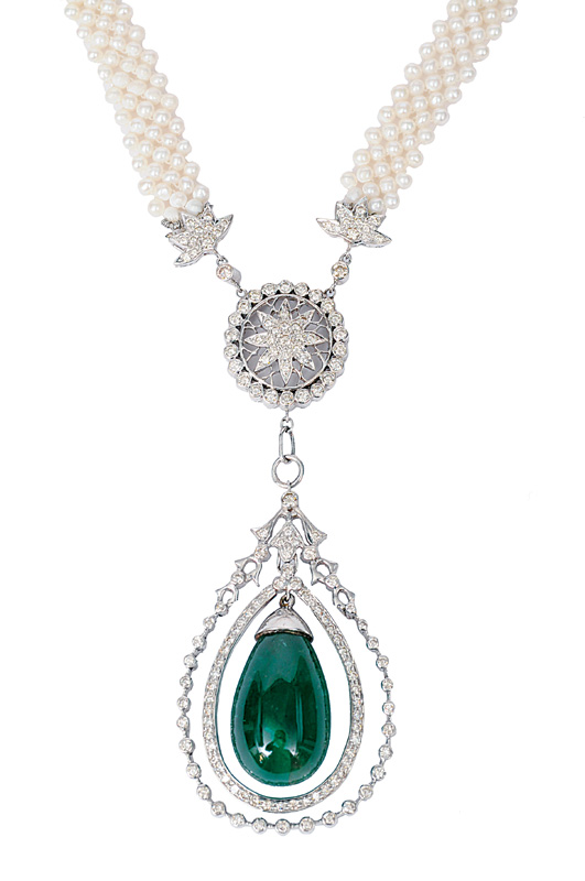 A pearl diamond necklace with a large emerald pendant