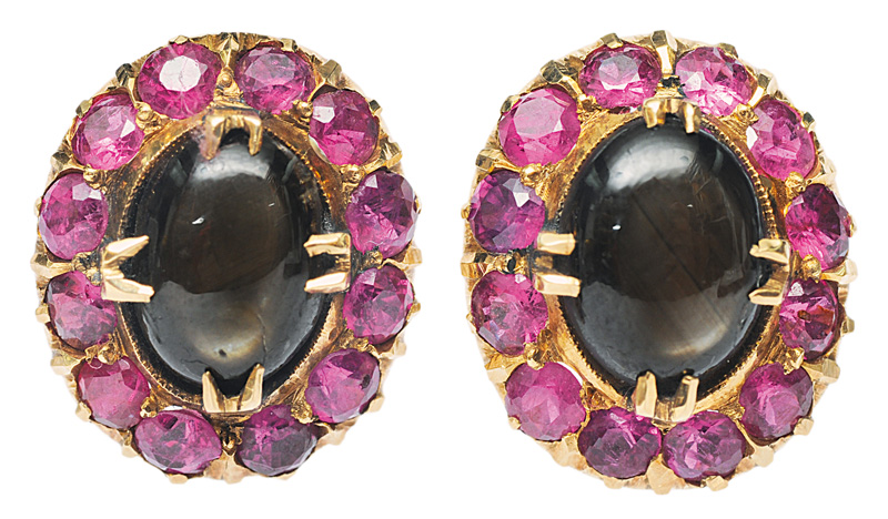 A pair of star sapphires earstuds with rubies