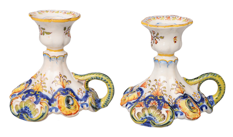 A pair of candlesticks with flower painting