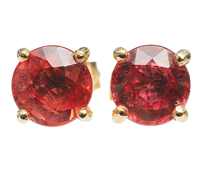 A pair of earstuds and matching ring with padparadscha sapphire