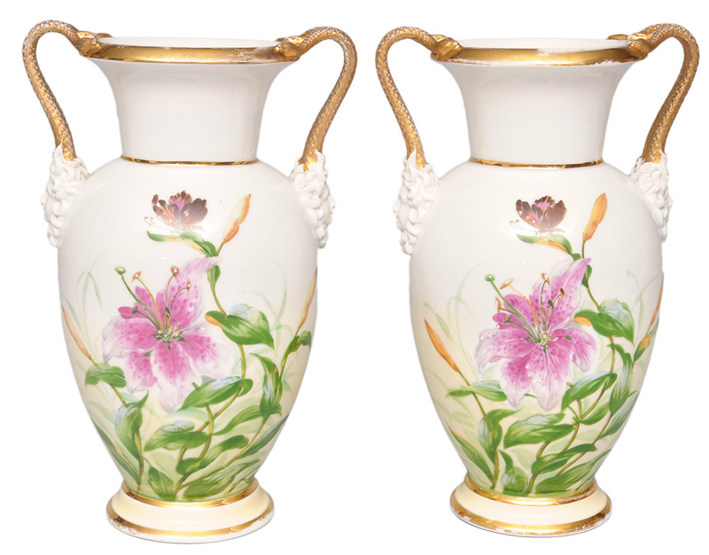 A pair of vases with snake handles and lillies