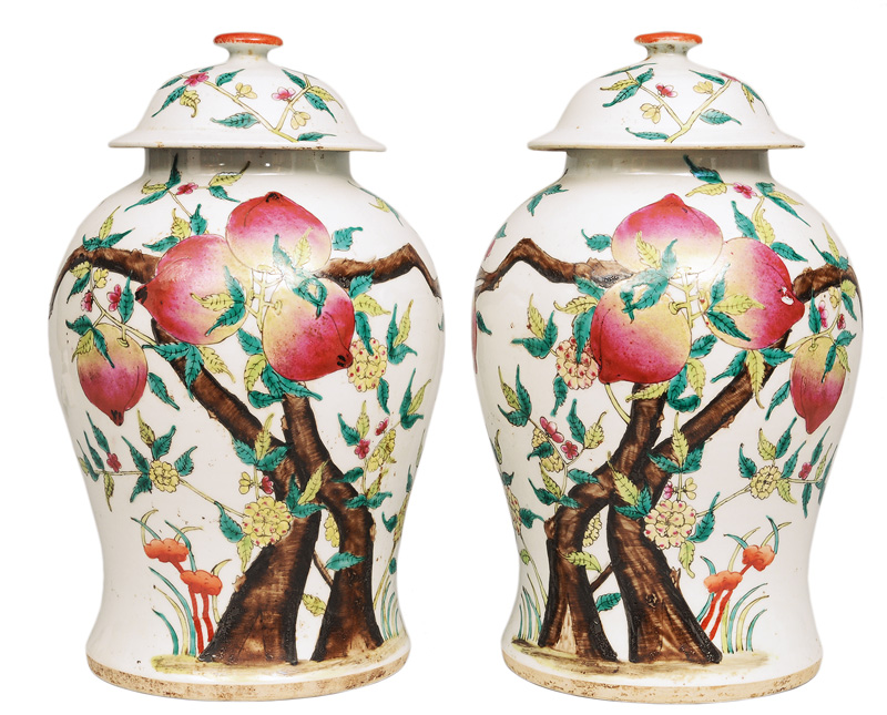 A pair of tall cover vases with peaches