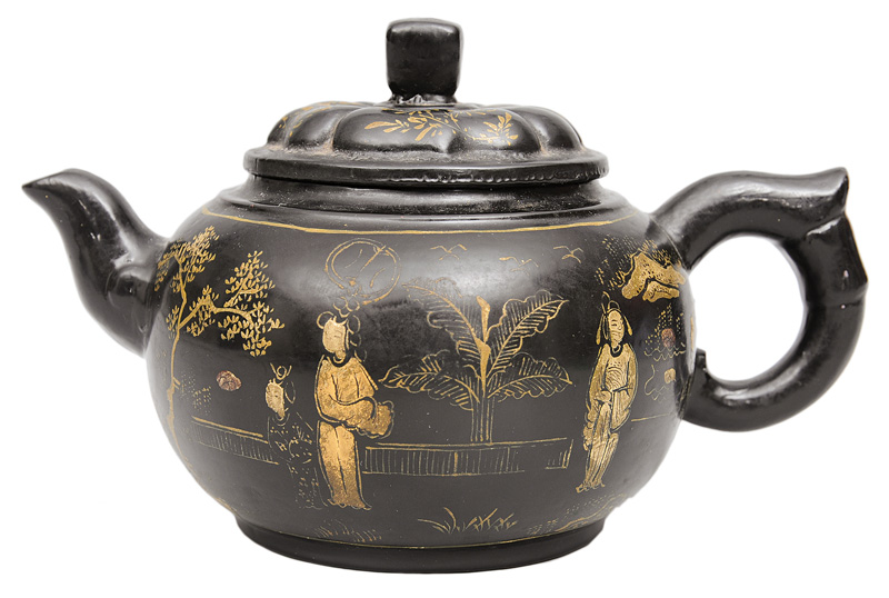 A black lacquered tea pot with fine gold decoration