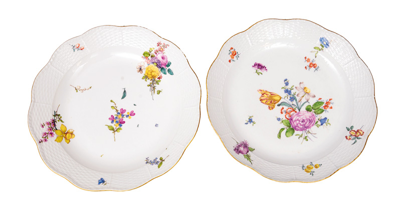 A pair of large circular plates with flower painting