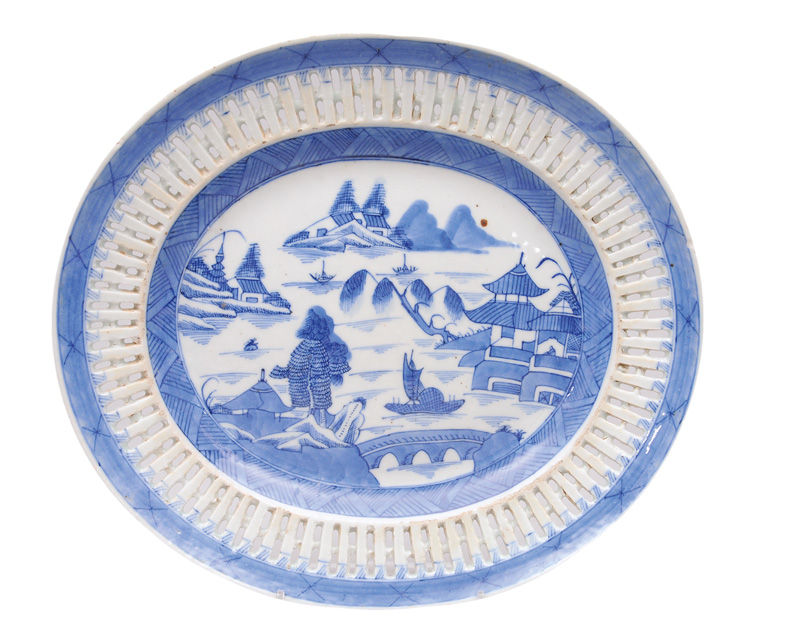 An oval fretwork plate with river landscape