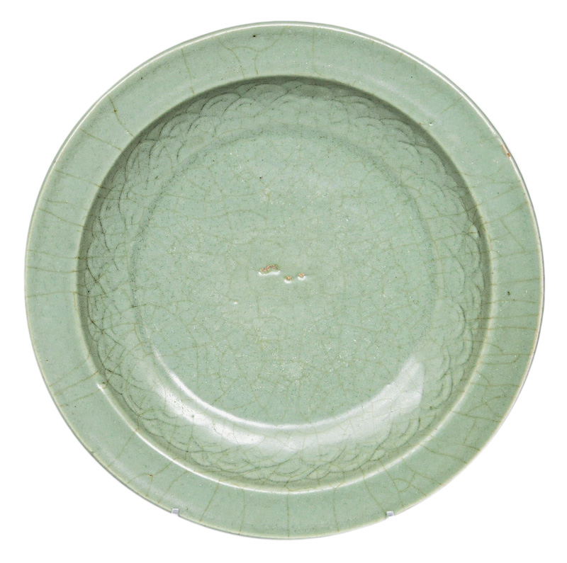 A celadon plate with wave decoration