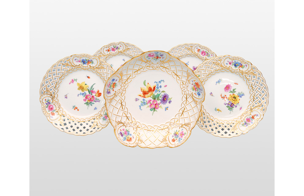 A set of four fretwork plates and a circular bowl