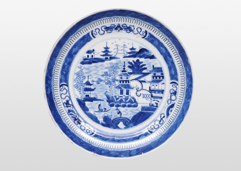 A plate with pagoda and Buddhist symbols