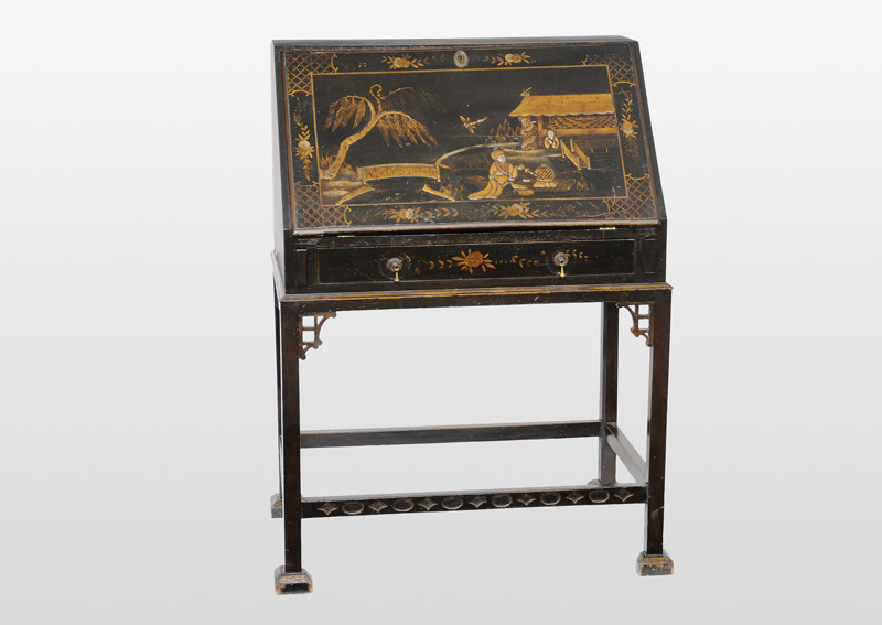 A lacquered bureau on stand with chinoisierie