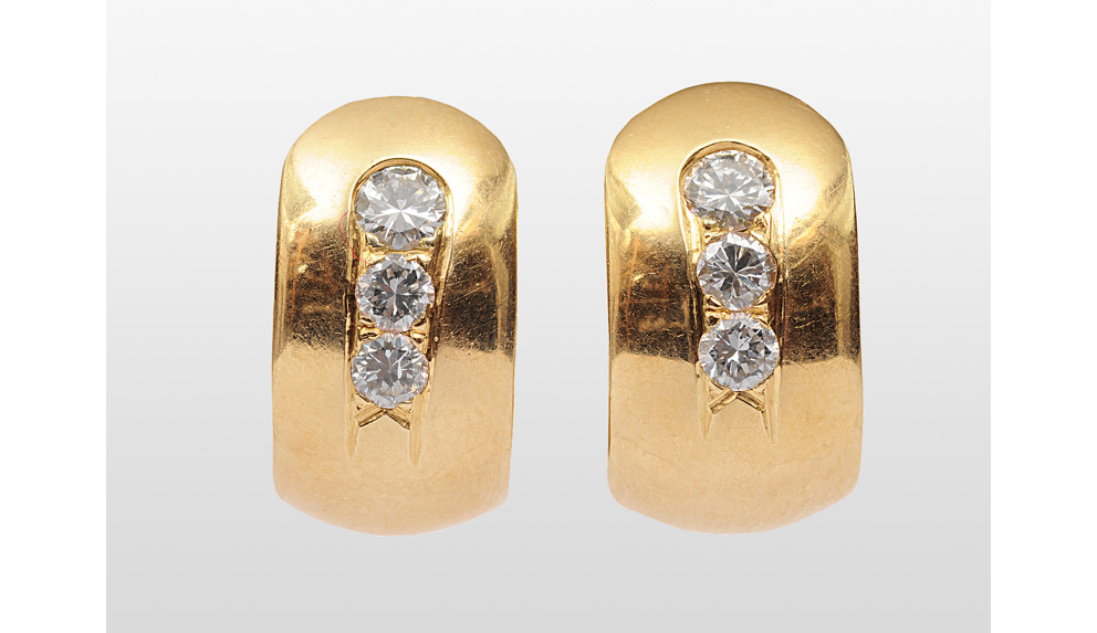 A pair of earrings with diamonds
