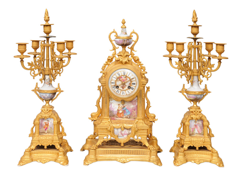 - A mantle clock with a pair of candle holders with porcellain application A mantle clock with a pair of candle holders with porcellain application
