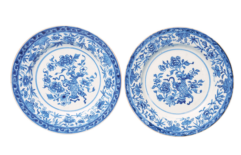 A pair of plates with vases