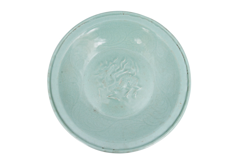A large moulded celadon plate with Qilin-creature