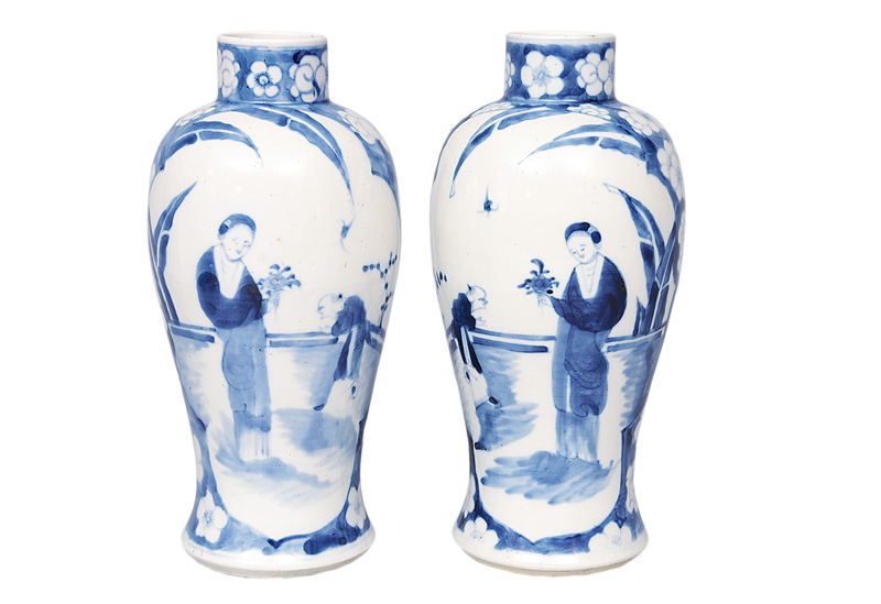 A pair of baluster vases with garden scenes