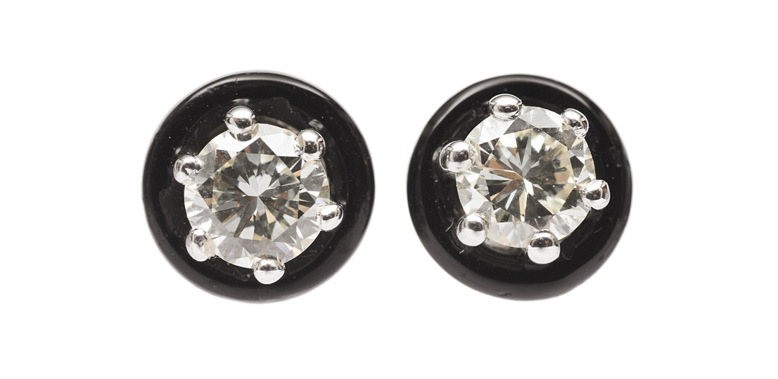 A pair of single stone diamond earstuds with onyx