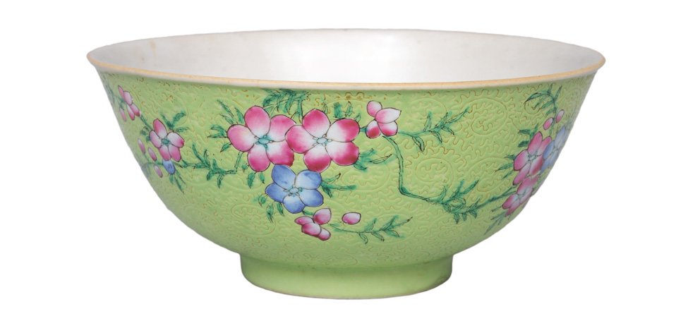 A green bowl with delicate relief decoration