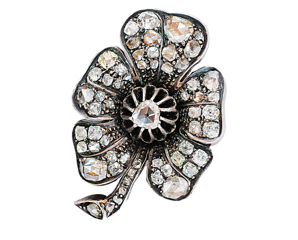 An antique flowershaped brooch with diamonds