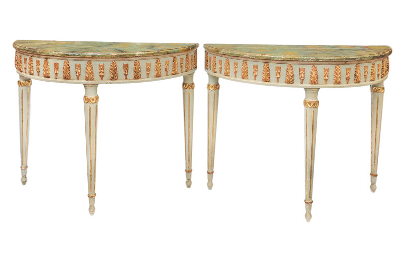 A pair of coloured demi lune console tables