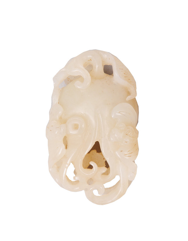 A white jade carving in the shape of a finger citron