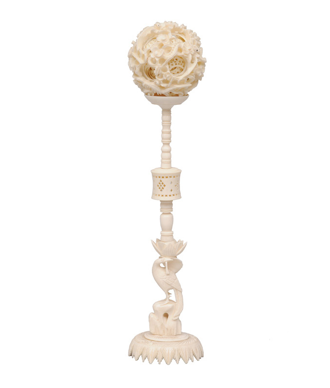 An ivory contrefait ball on stand