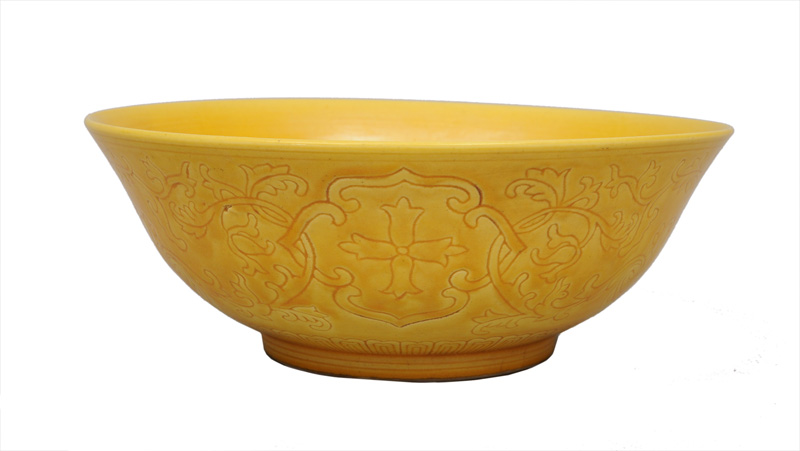 A yellow bowl with flower decoration