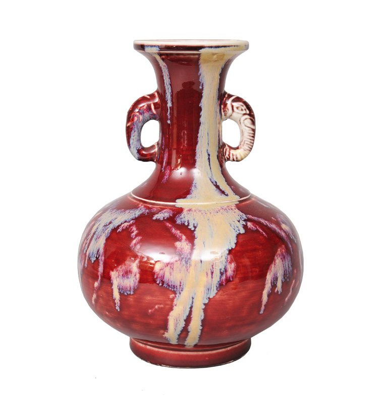 An elegant flambé-glazed vase with elephant handles